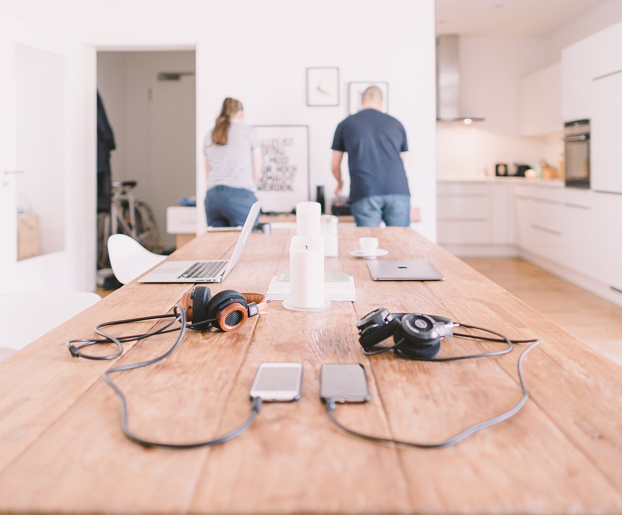 A couple working together on finances at home, reviewing a shared budget on a laptop